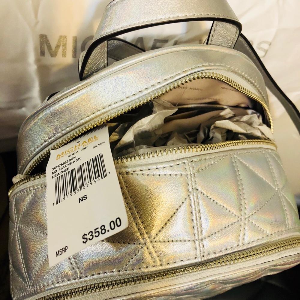 Silver Micheal Kors backpack.